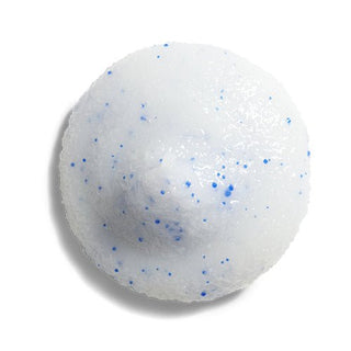 White bath bomb with blue specks on a white background