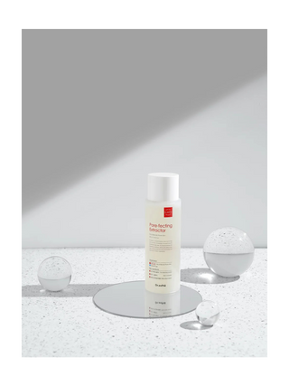 Skincare bottle on a reflective surface with a neutral background