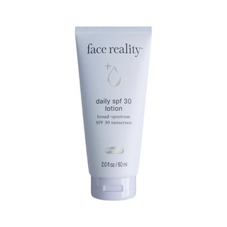 Tube of 'face reality' daily SPF 30 lotion on a white background