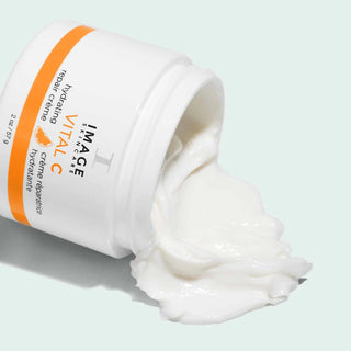 Jar of IMAGE Skincare Vital C repair crème with cream spilling out on a light background