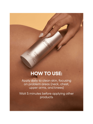 Hand holding a skincare product with application instructions on a beige background