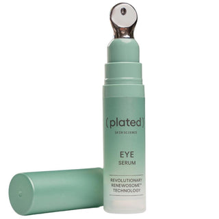 Plated eye serum bottle with cap on a white background