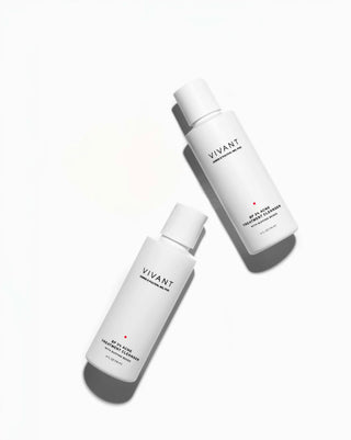 Two white cylindrical skincare bottles from VIVANT Skin Science, one labeled Treatment Line and the other B50+ Pure Treatment Cleanser, arranged diagonally on a clean white background with soft shadows.