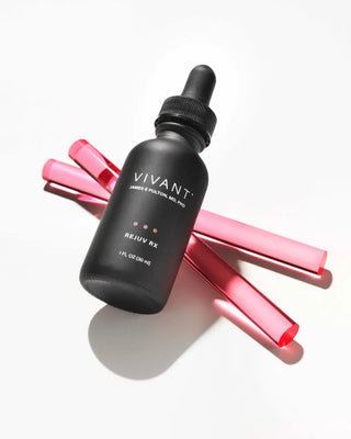 A black glass dropper bottle labeled VIVANT REJUV RX, styled diagonally with three translucent pink cosmetic tubes on a clean white background.