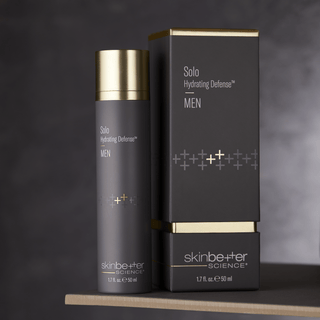Skinbetter solo hydrating defense men 50ml bottle on a table next to the package.